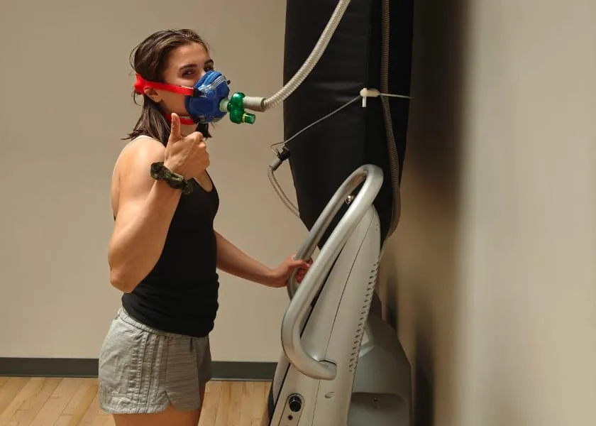 A client breathing high-concentration oxygen through a mask during an exercise with oxygen therapy session at Active Healing