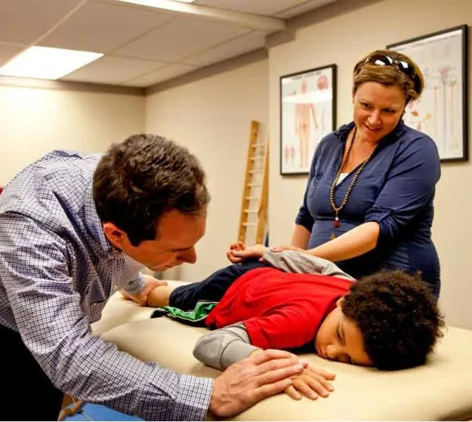Sargent Goodchild working with a child during a NeuroDevelopmental Movement session